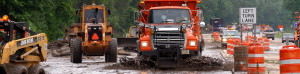 Removing mud from roadway after flooding