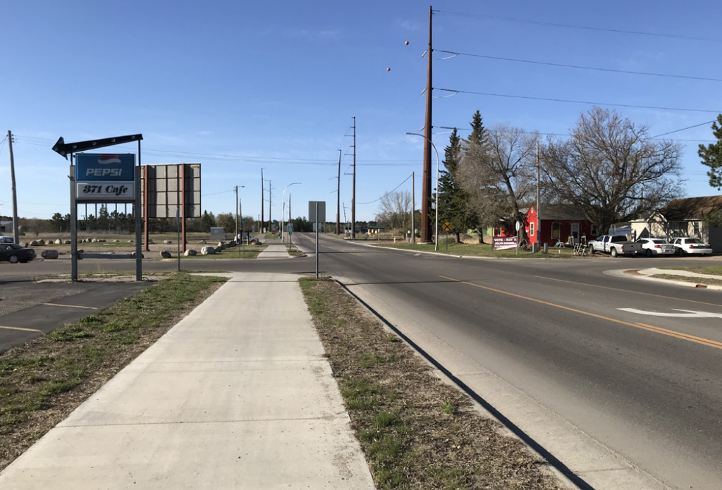 Highway 371 in Cass Lake, MN after construction, showing sidewalks, lane adjustment, and multi-use path