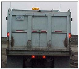 Rear of tandem axle dump truck with proper approved lighting package. Light can be seen at all times from sixty feet away.