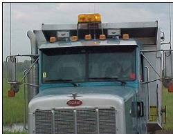 Tandem axle dump truck with proper approved safety lighting.