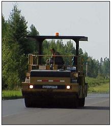 Roller working on a project with approved safety lighting.