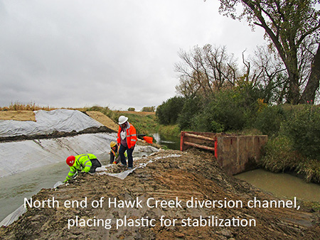 North end of Hawk Creek diversion channel, placing plastic for stabilization