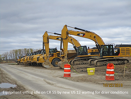 Equipment sitting idle on CR 55 by new US 12 waiting for drier conditions