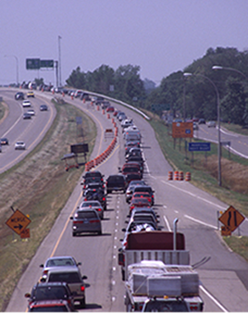 Drivers using both lanes as they zipper merge into a single lane