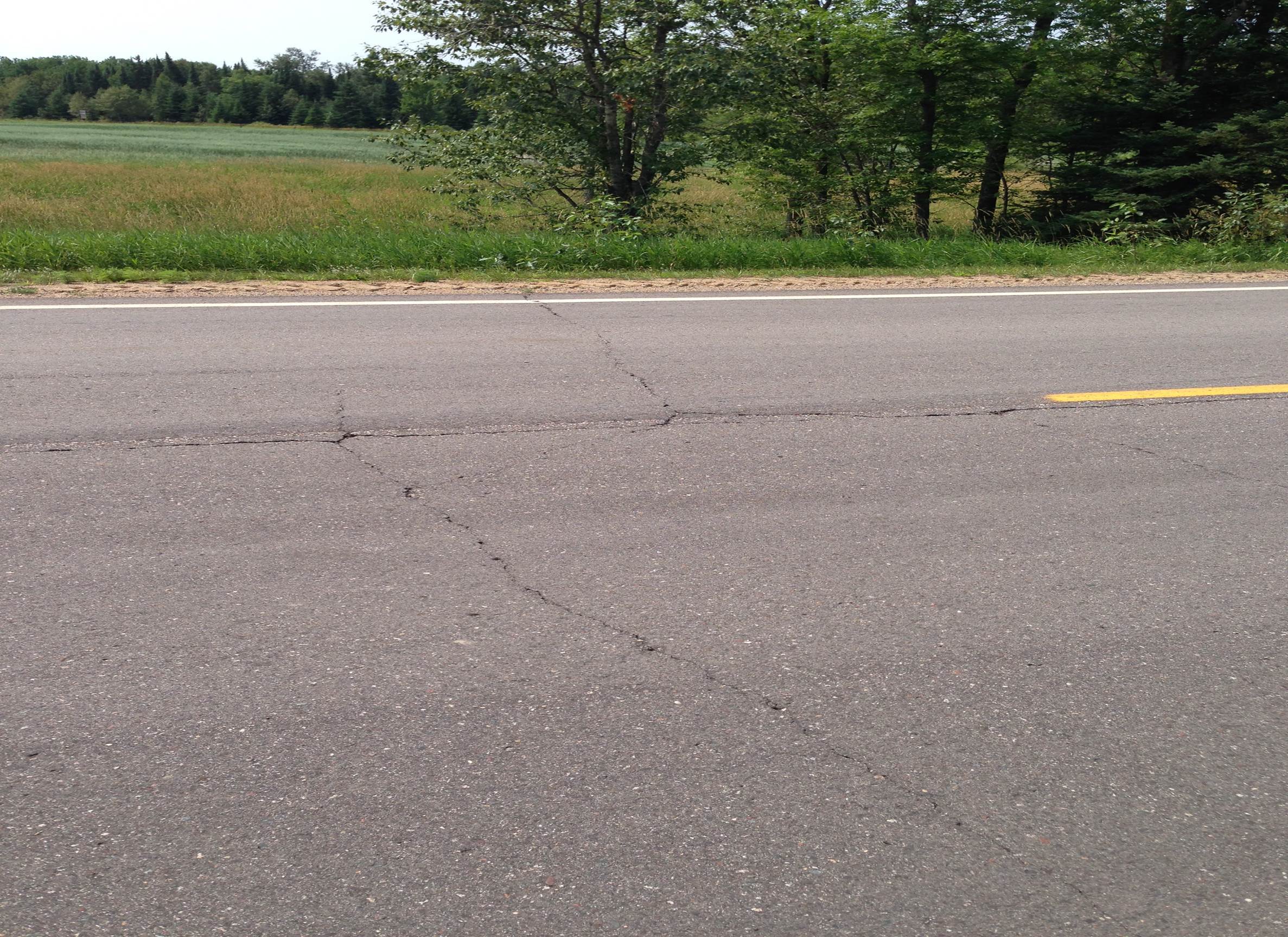 Low-temperature cracks in asphalt pavement can cross entire lanes of traffic.