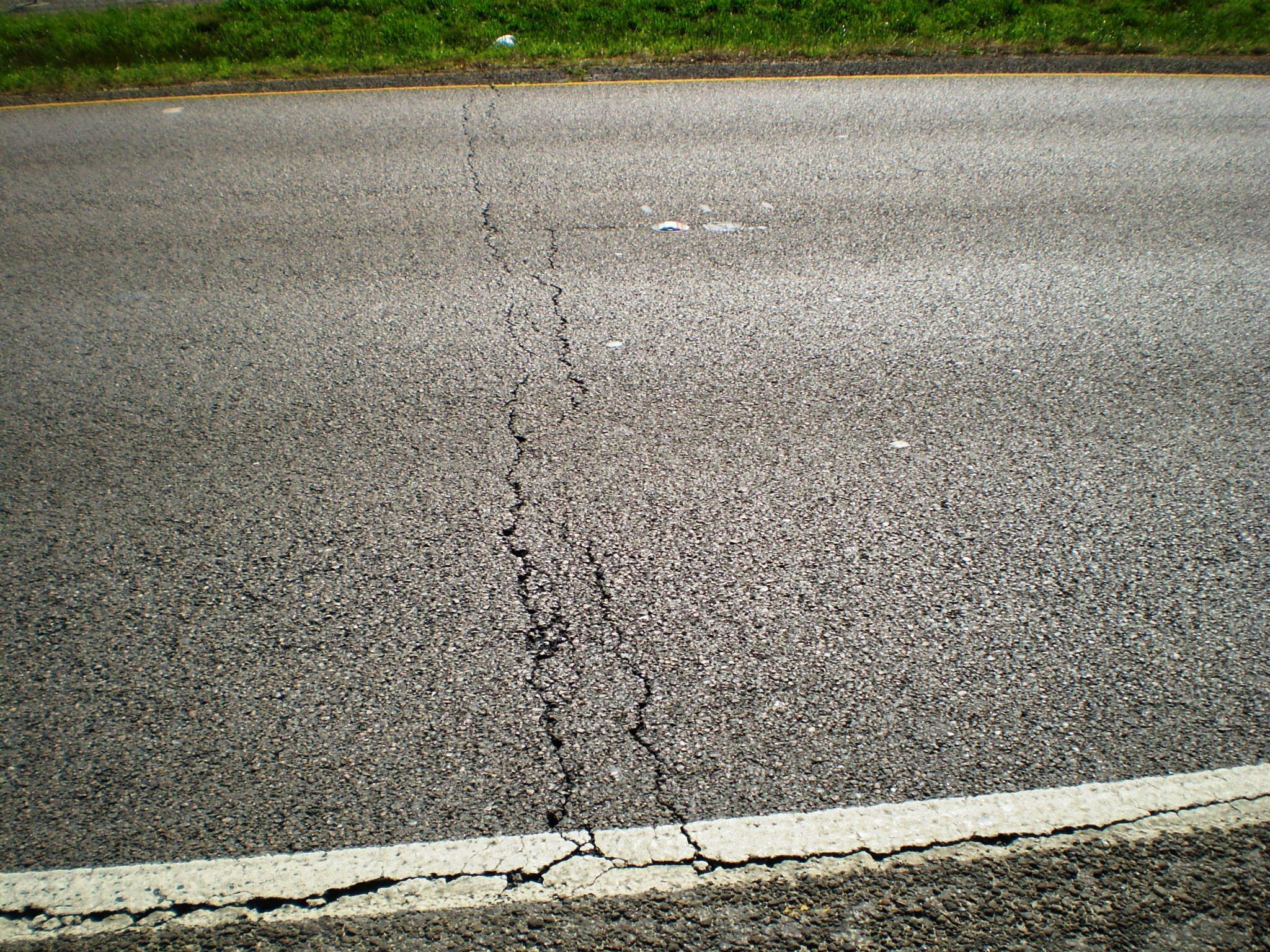 Low-temperature cracking can trigger fissures that span entire lanes of pavement, as shown here on a highway near Beaumont, Minnesota.