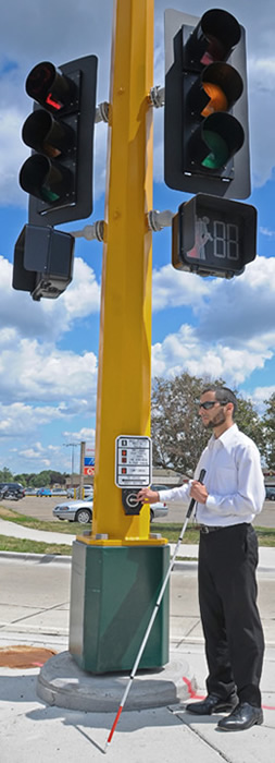 image of man next to accessible pedestrian signal